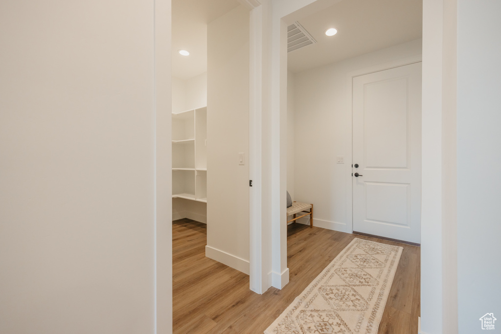 Hallway featuring light wood finished floors and recessed lighting