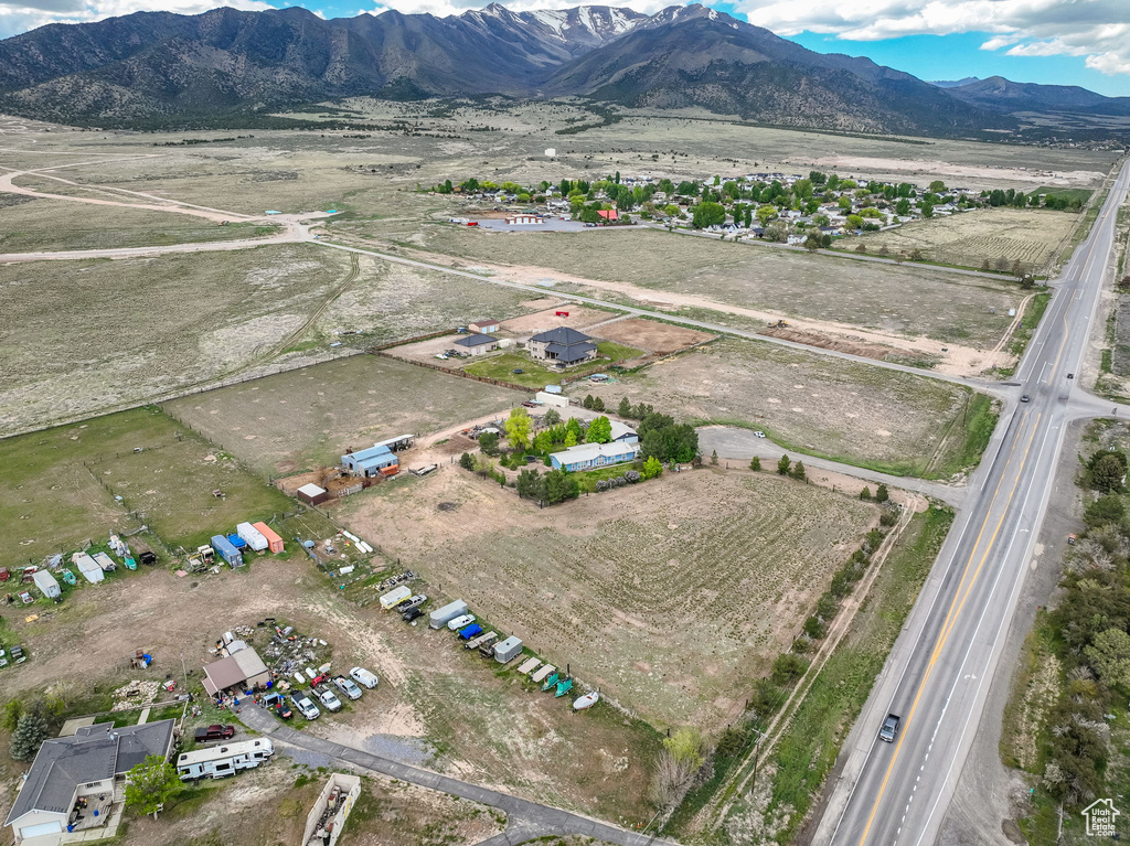 Aerial view of property and surrounding area with mountains and rural landscape