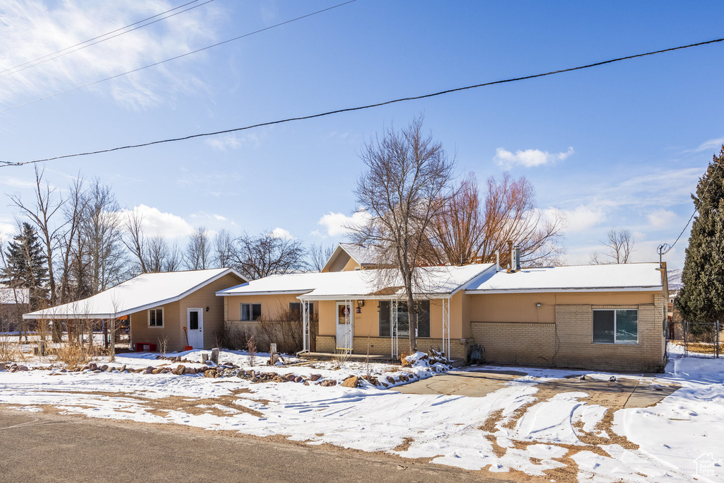 Single story home featuring brick siding