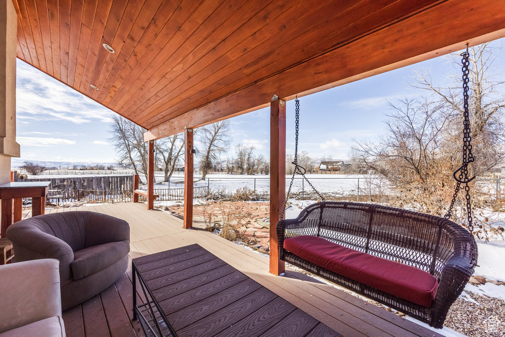 Snow covered deck featuring an outdoor hangout area