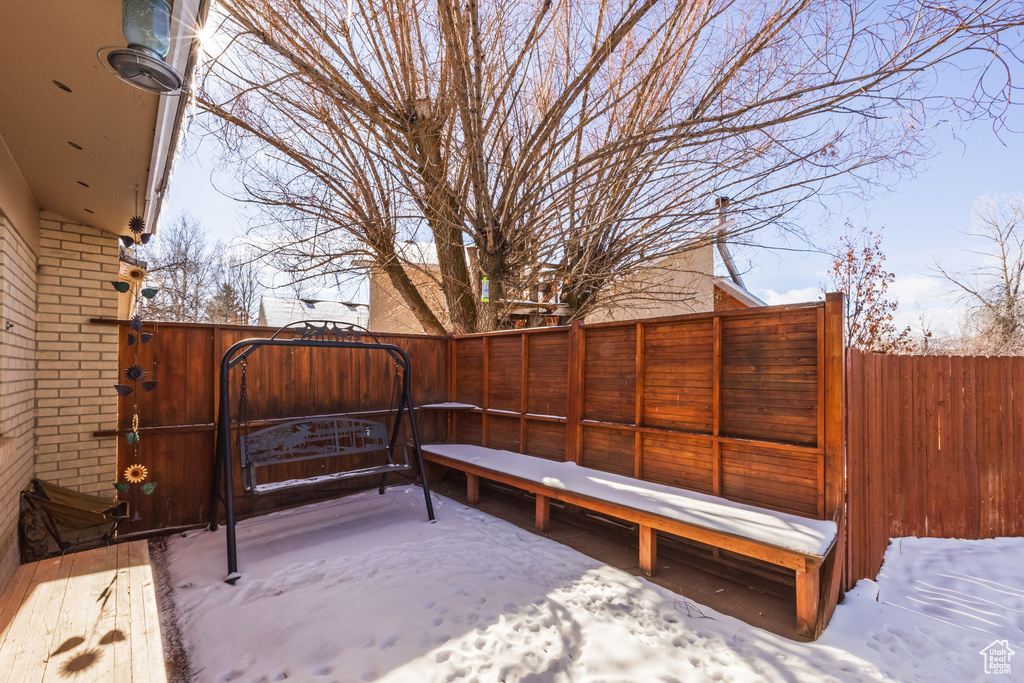 Snow covered patio with a gate