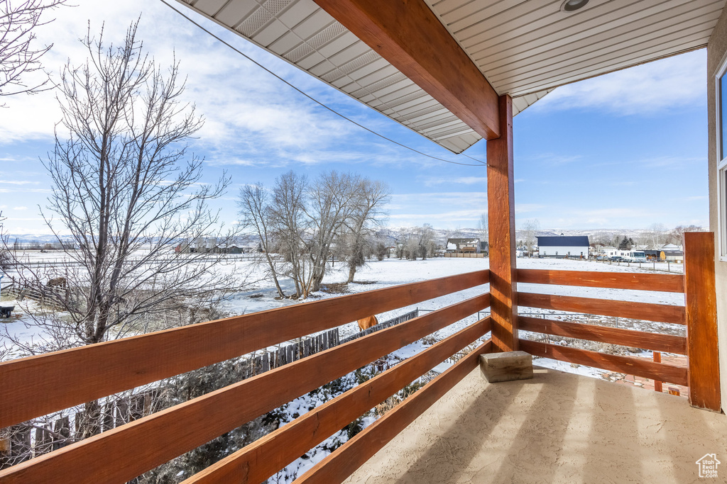 View of snow covered back of property