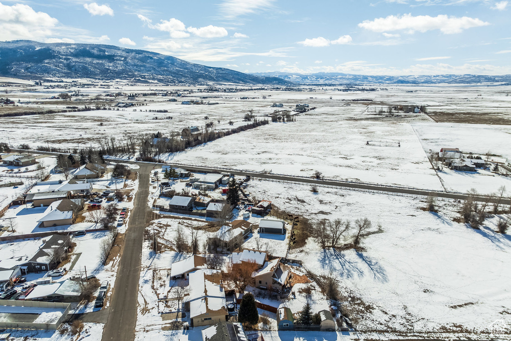 Snowy aerial view featuring a mountain view