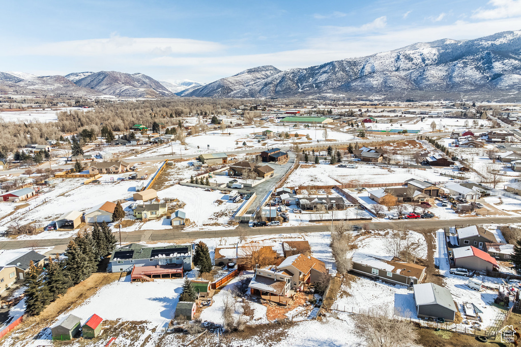 Snowy aerial view featuring a residential view and a mountain view