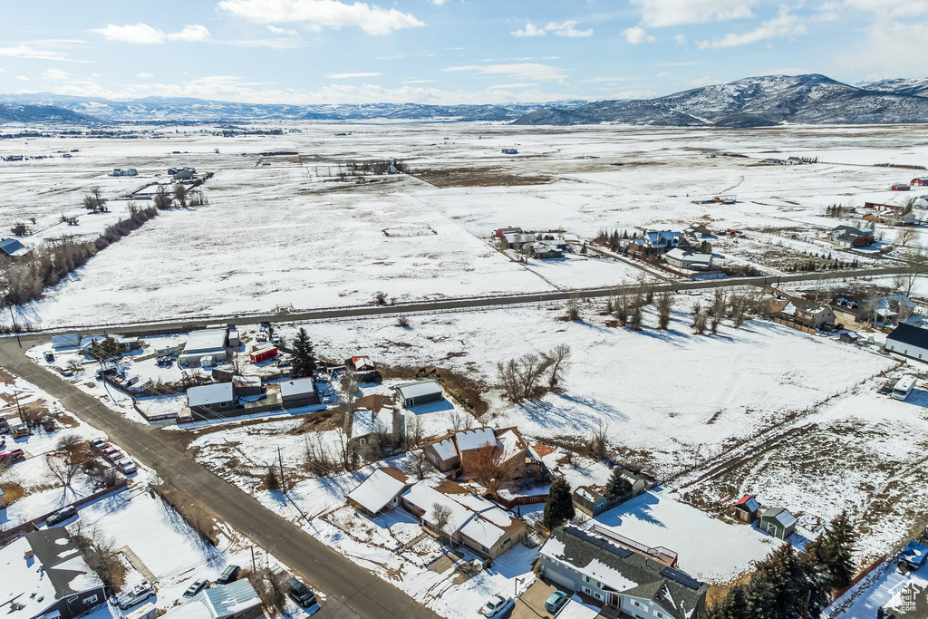 Snowy aerial view featuring a mountain view