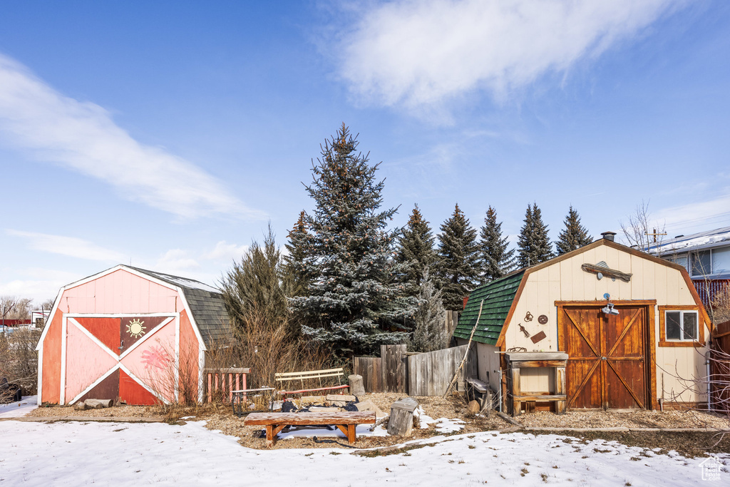 Snow covered structure with a shed
