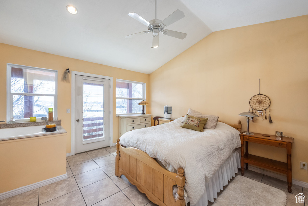 Bedroom featuring access to exterior, vaulted ceiling, baseboards, light tile patterned flooring, and ceiling fan