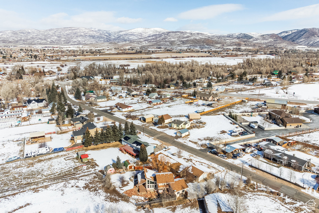 Snowy aerial view with a mountain view and a residential view