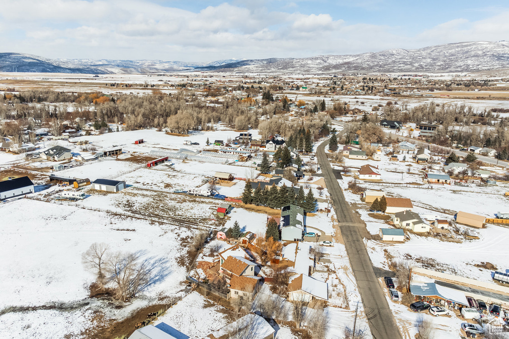 Snowy aerial view featuring a mountain view