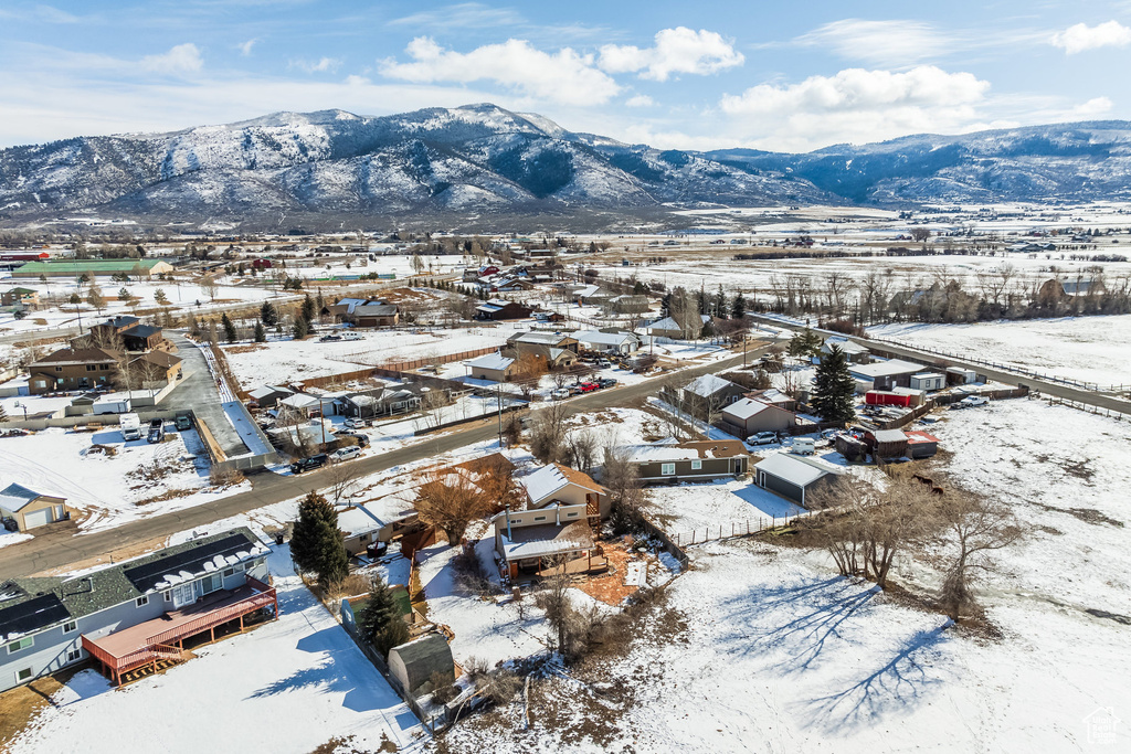 Snowy aerial view with a residential view and a mountain view