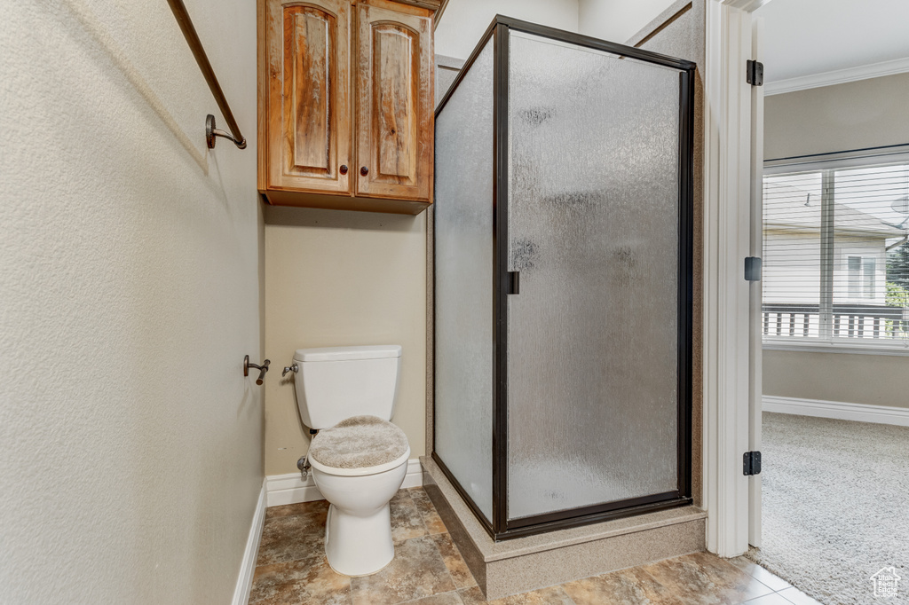 Bathroom featuring a stall shower and ornamental molding