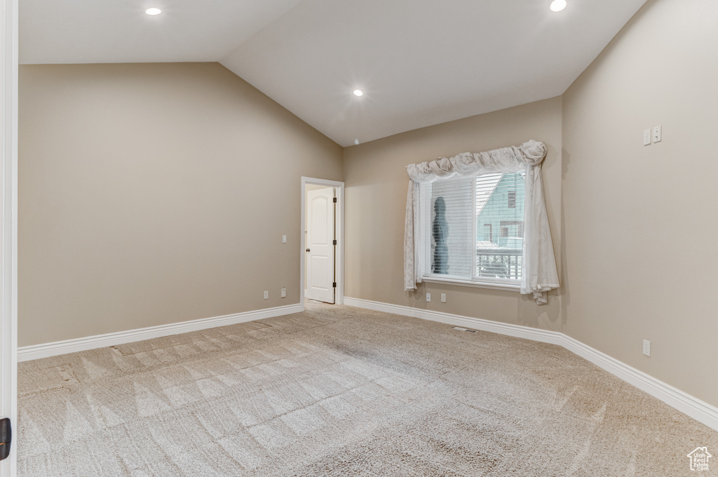 Spare room with carpet, recessed lighting, and lofted ceiling