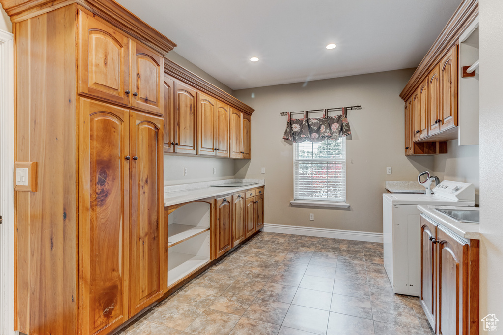 Laundry room featuring cabinet space, washer and dryer, recessed lighting, and light tile patterned floors