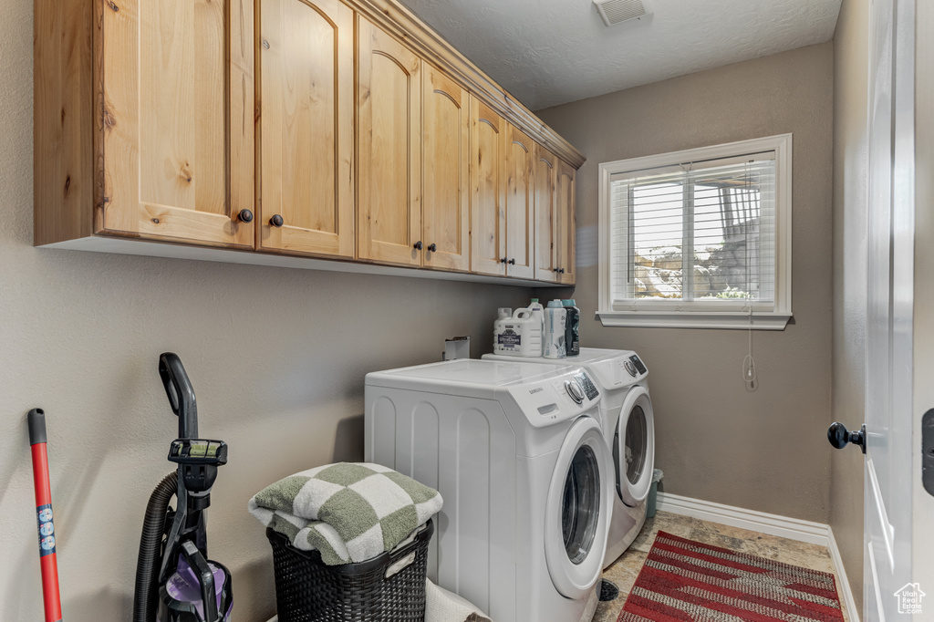 Laundry area with washing machine and clothes dryer and cabinet space
