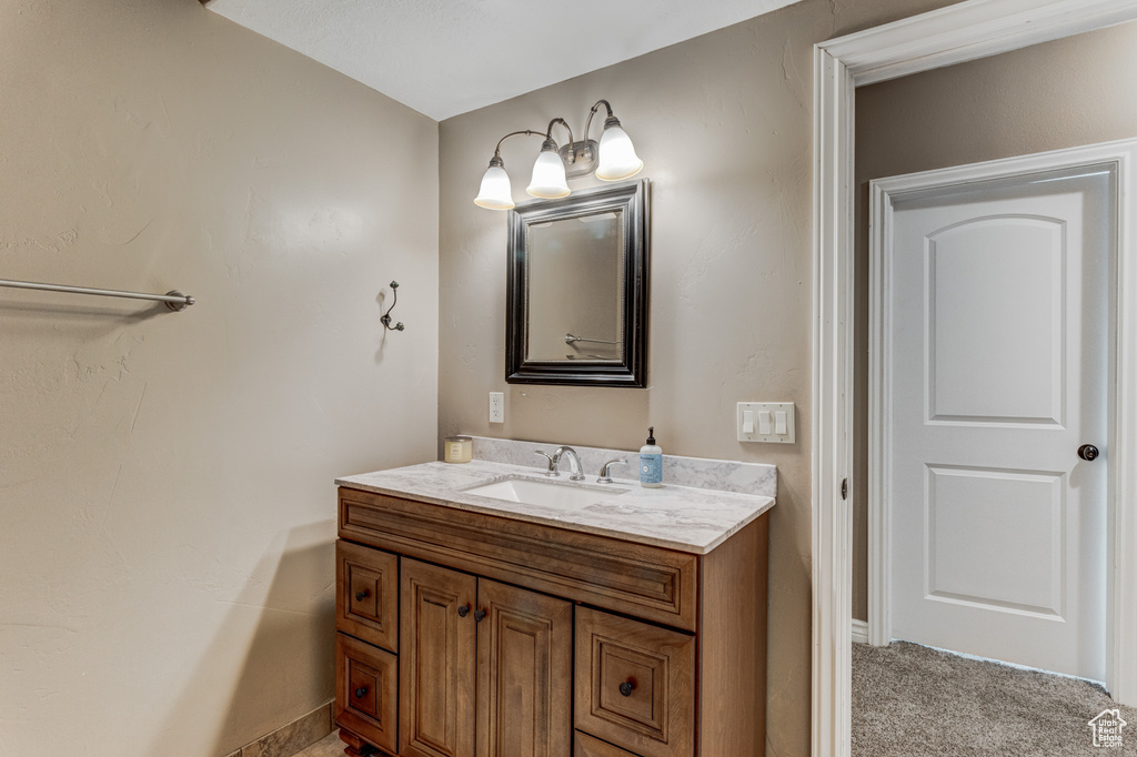 Bathroom featuring vanity and baseboards