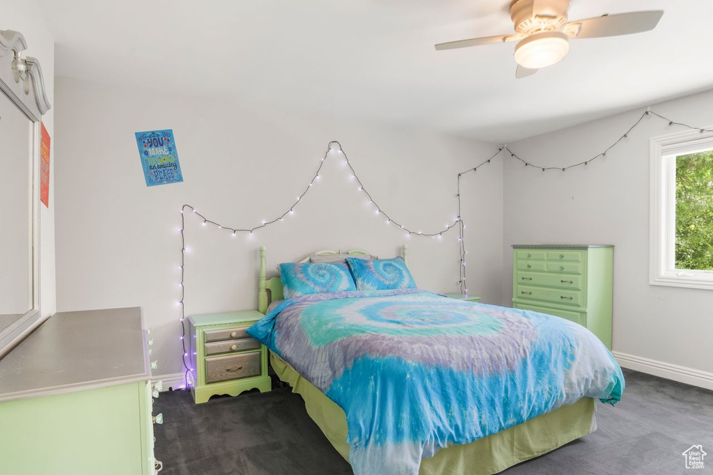 Carpeted bedroom with ceiling fan