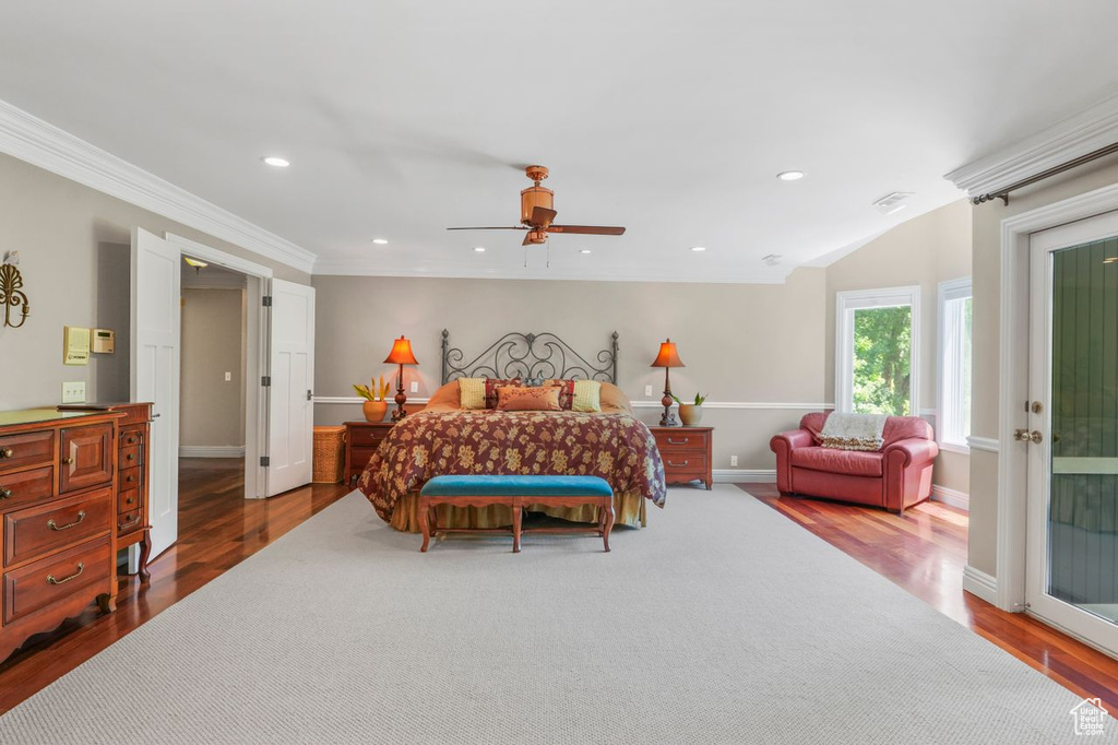 Bedroom with hardwood / wood-style floors, ceiling fan, and ornamental molding