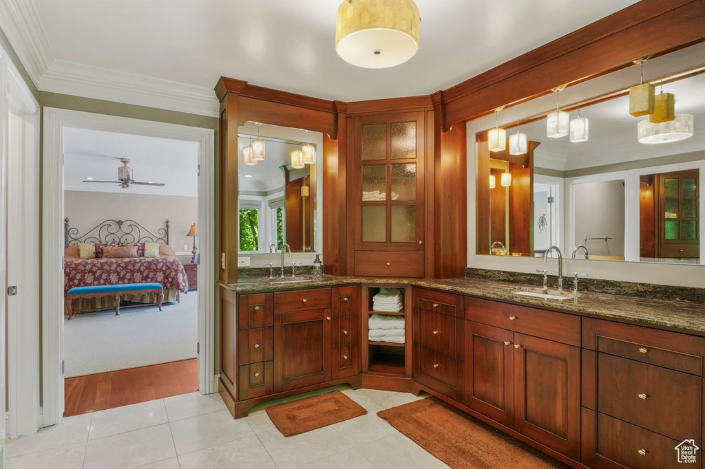 Bathroom featuring tile patterned floors, crown molding, vanity, and ceiling fan