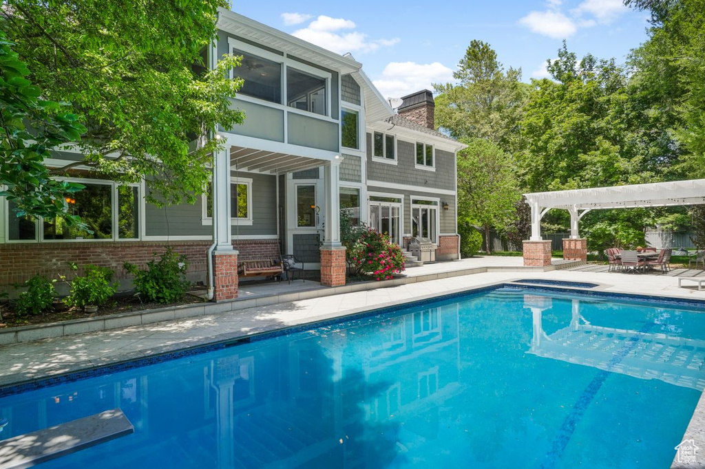 View of pool featuring a pergola and a patio area