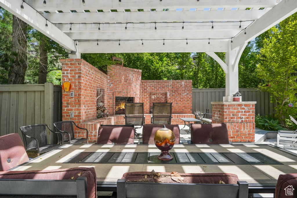 View of patio / terrace featuring a pergola and an outdoor living space with a fireplace
