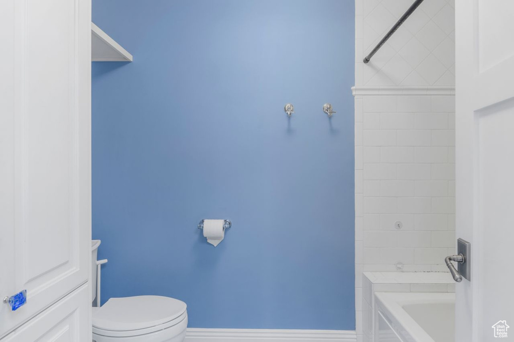 Bathroom with a tub to relax in and toilet