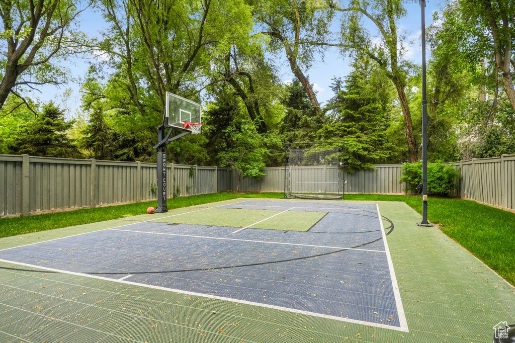 View of sport court featuring a yard