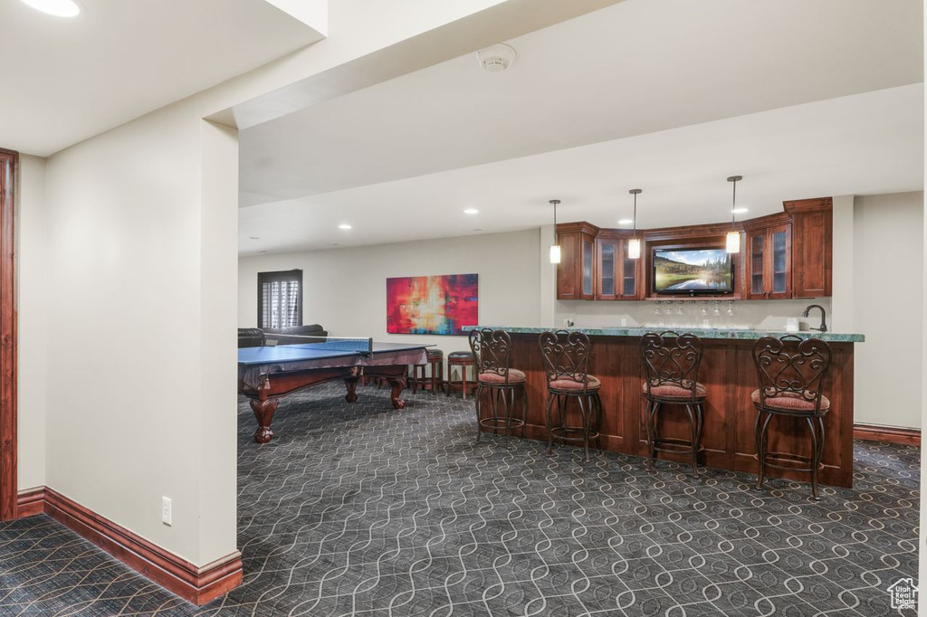 Bar featuring sink and hanging light fixtures