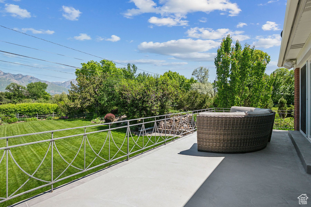 View of patio with a balcony and a mountain view