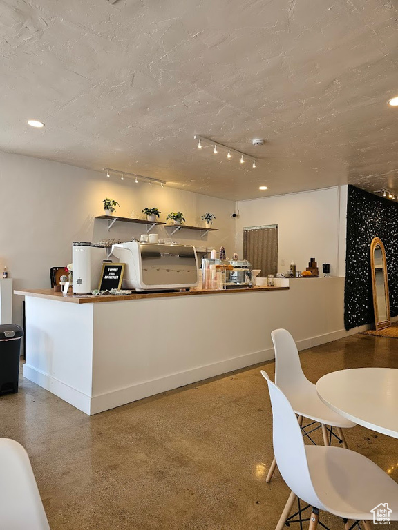 Kitchen with rail lighting and baseboards