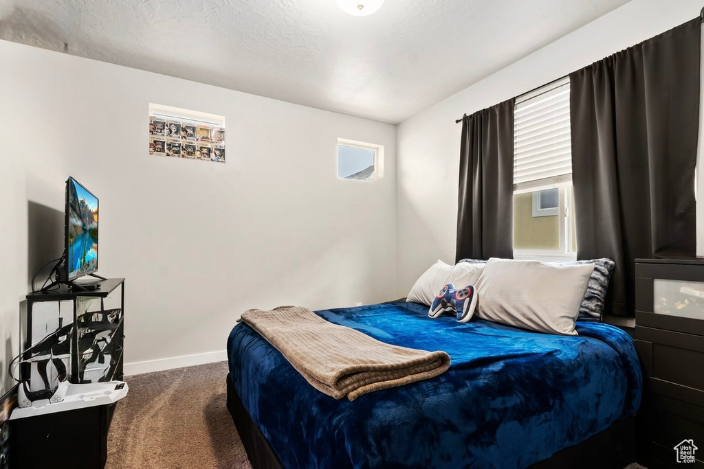 Carpeted bedroom with baseboards