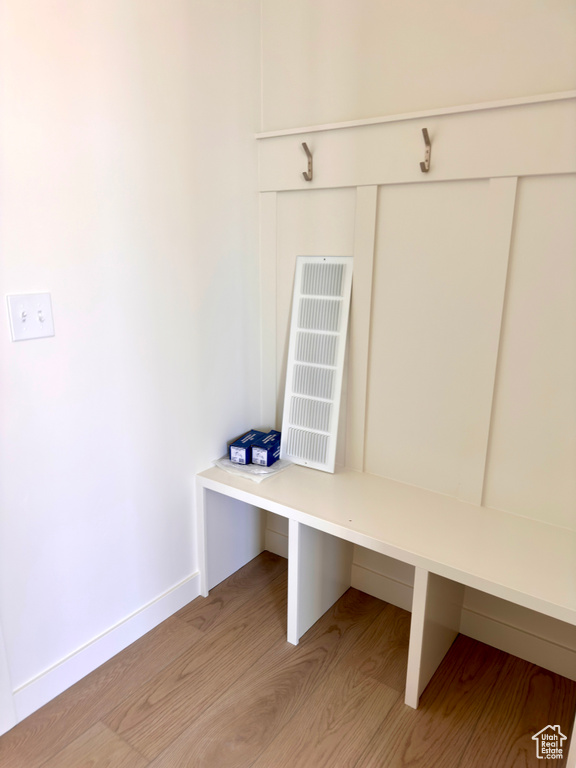 Mudroom with baseboards and light wood-style flooring