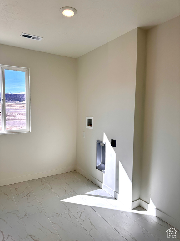 Spare room with visible vents, marble finish floor, and baseboards