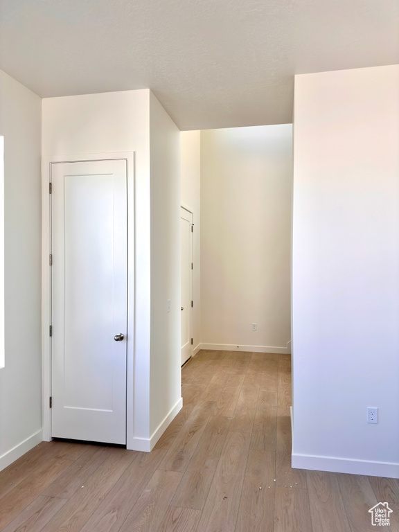 Interior space with baseboards and light wood-style floors