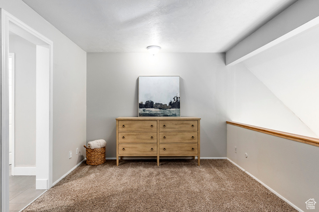 Bedroom with beamed ceiling, carpet floors, and baseboards