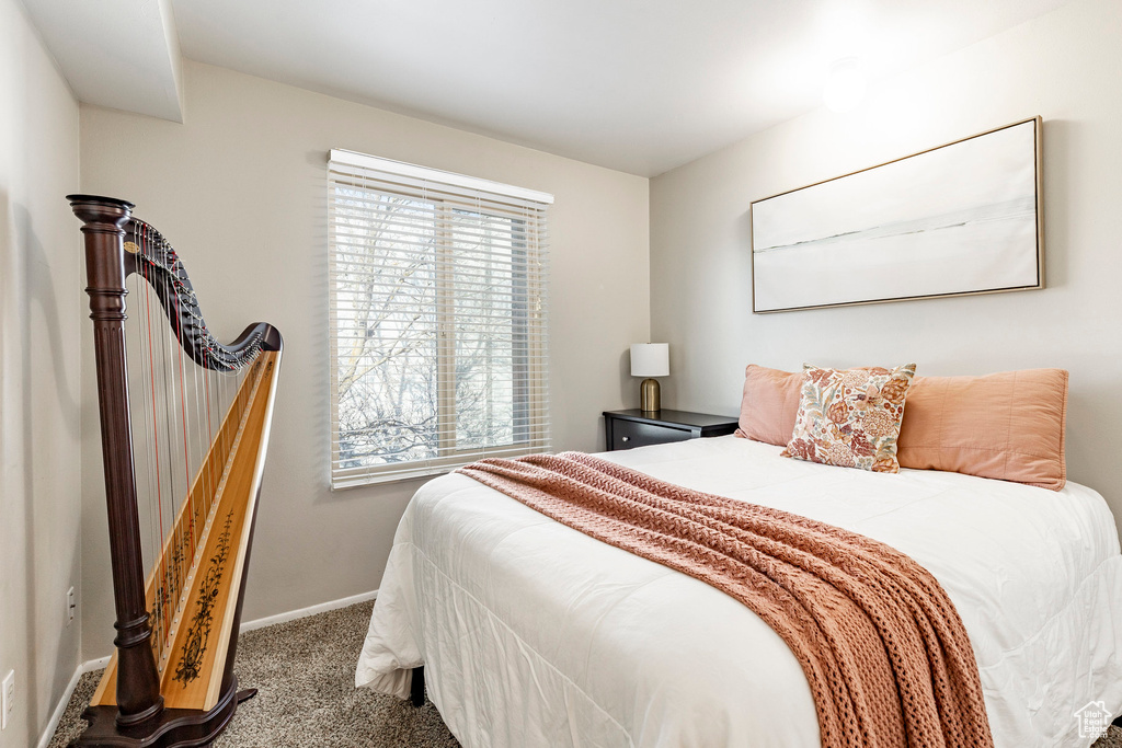 Bedroom featuring carpet flooring and baseboards