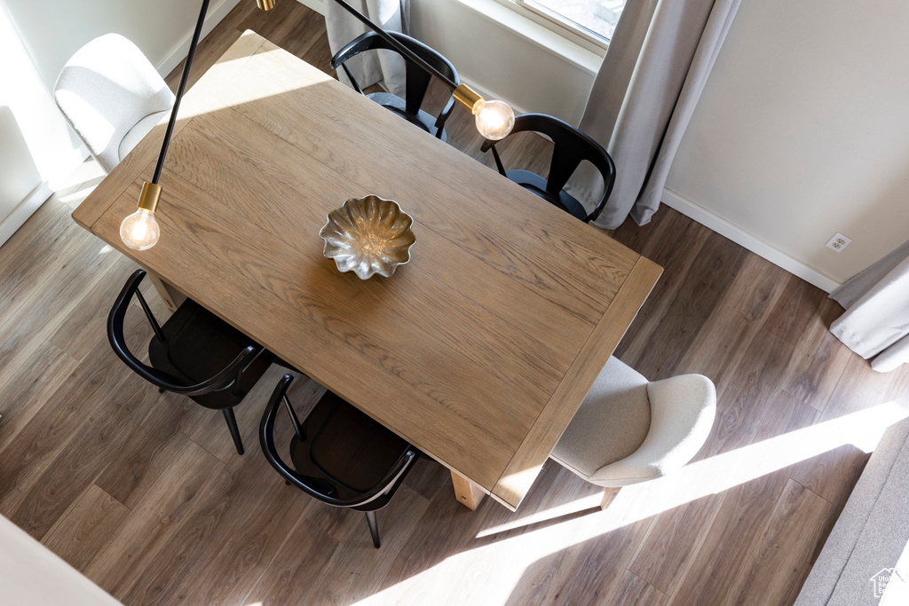 Dining area with baseboards and wood finished floors