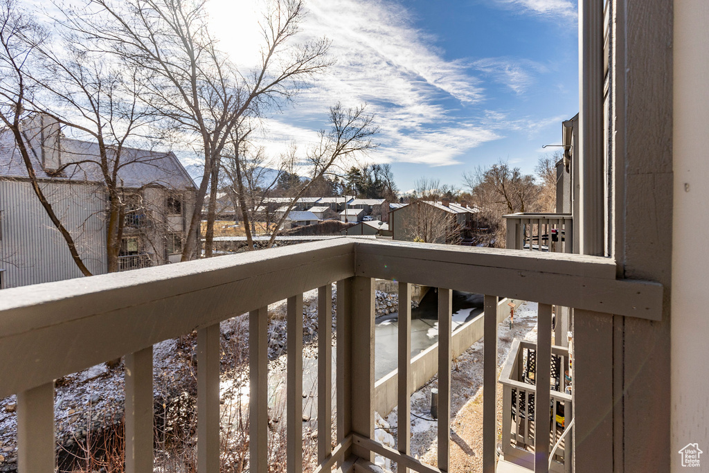 Snow covered back of property featuring a residential view