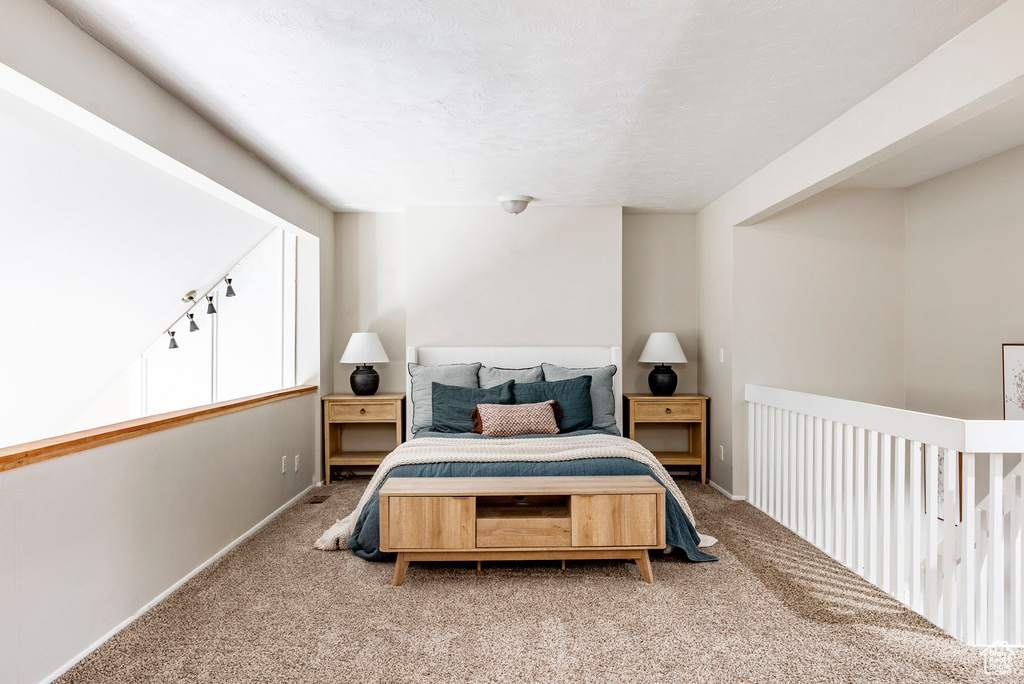 Carpeted bedroom with baseboards