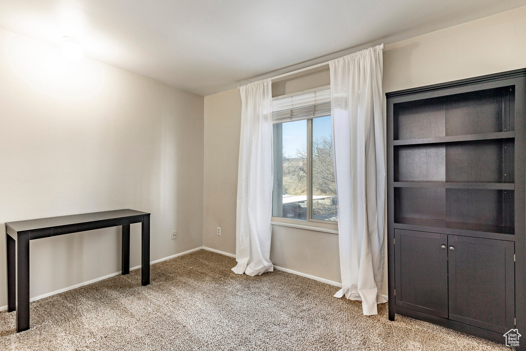 Interior space with light carpet and baseboards