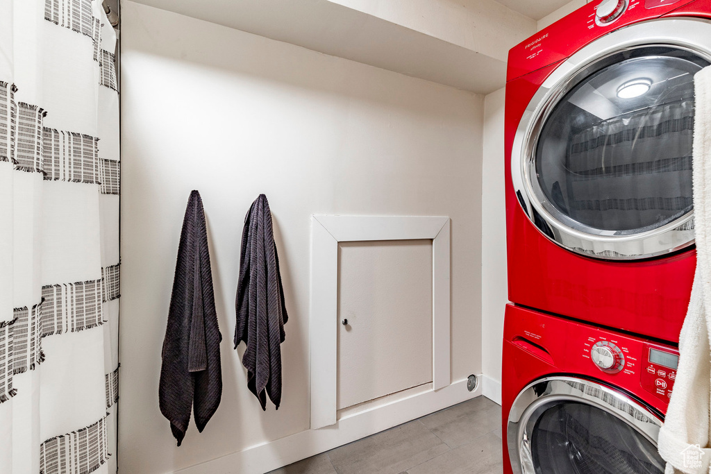 Washroom with laundry area and stacked washer and clothes dryer