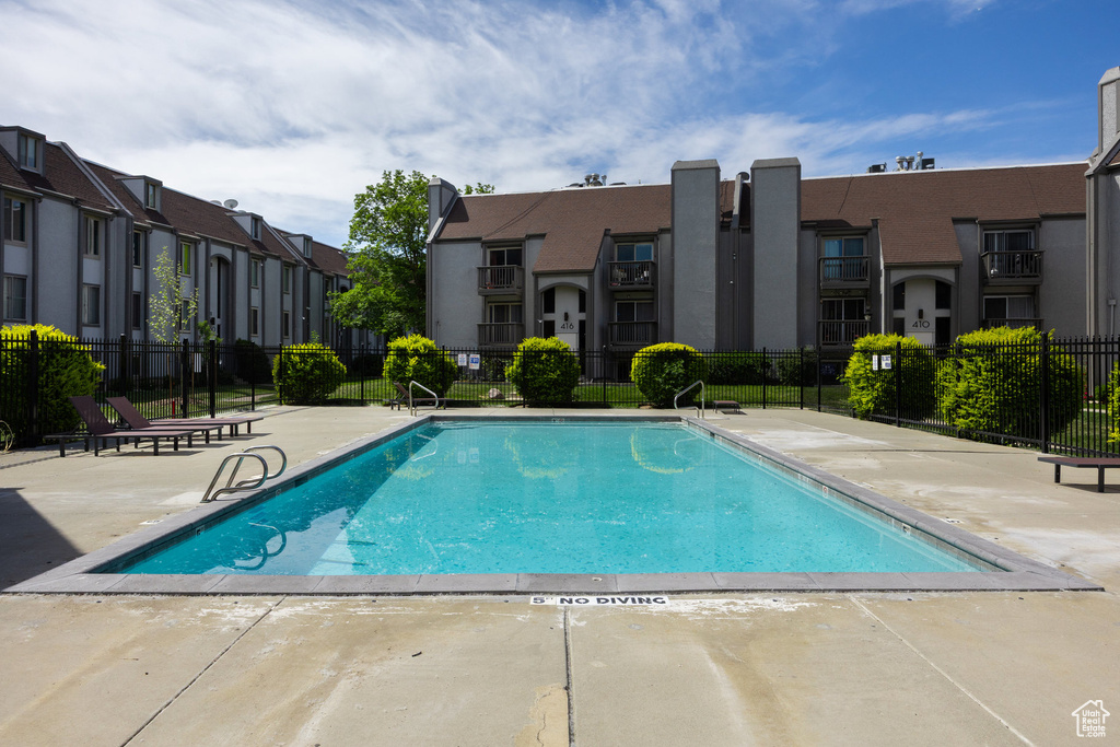 Community pool featuring a residential view and a patio