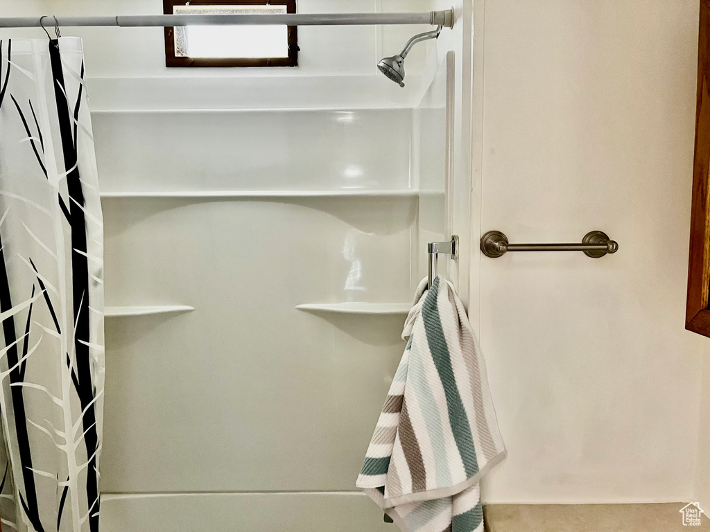 Bathroom featuring curtained shower