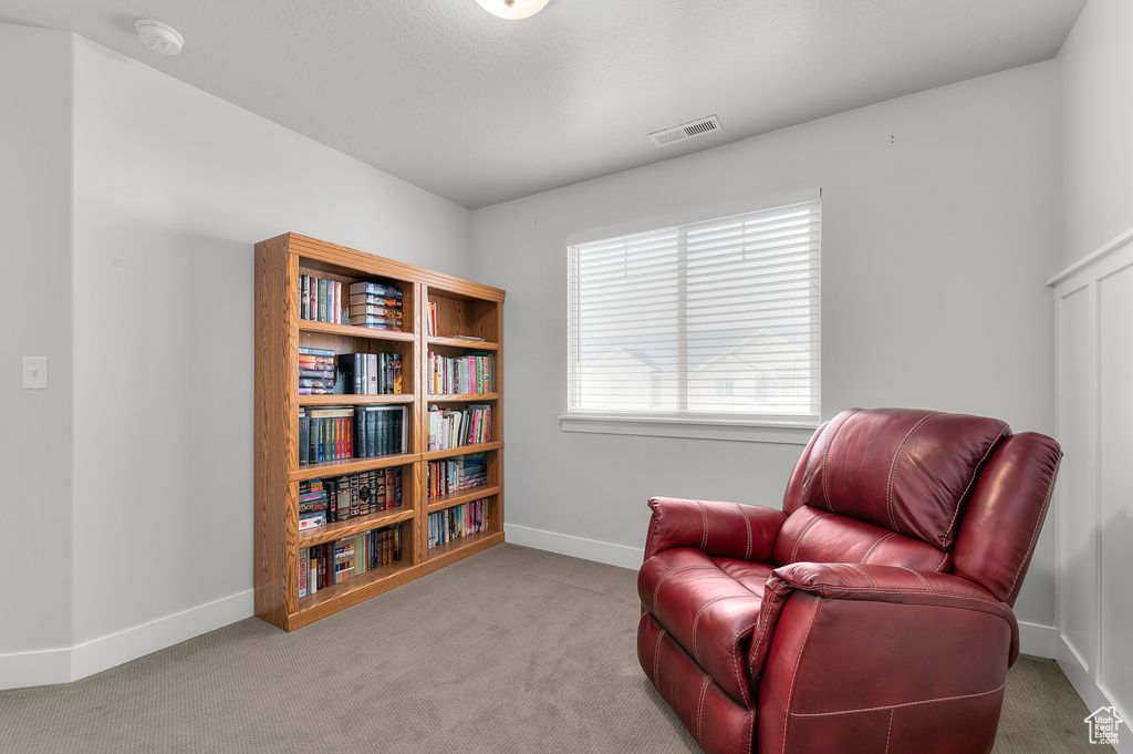 Sitting room featuring light colored carpet