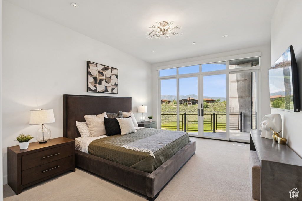Bedroom with access to exterior, light carpet, and recessed lighting