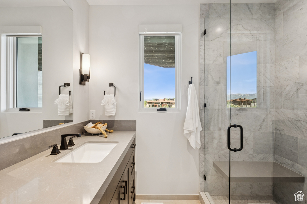 Full bathroom featuring vanity and a stall shower