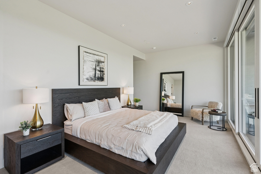 Bedroom with light carpet and recessed lighting