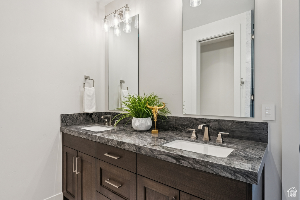 Full bath with double vanity and baseboards