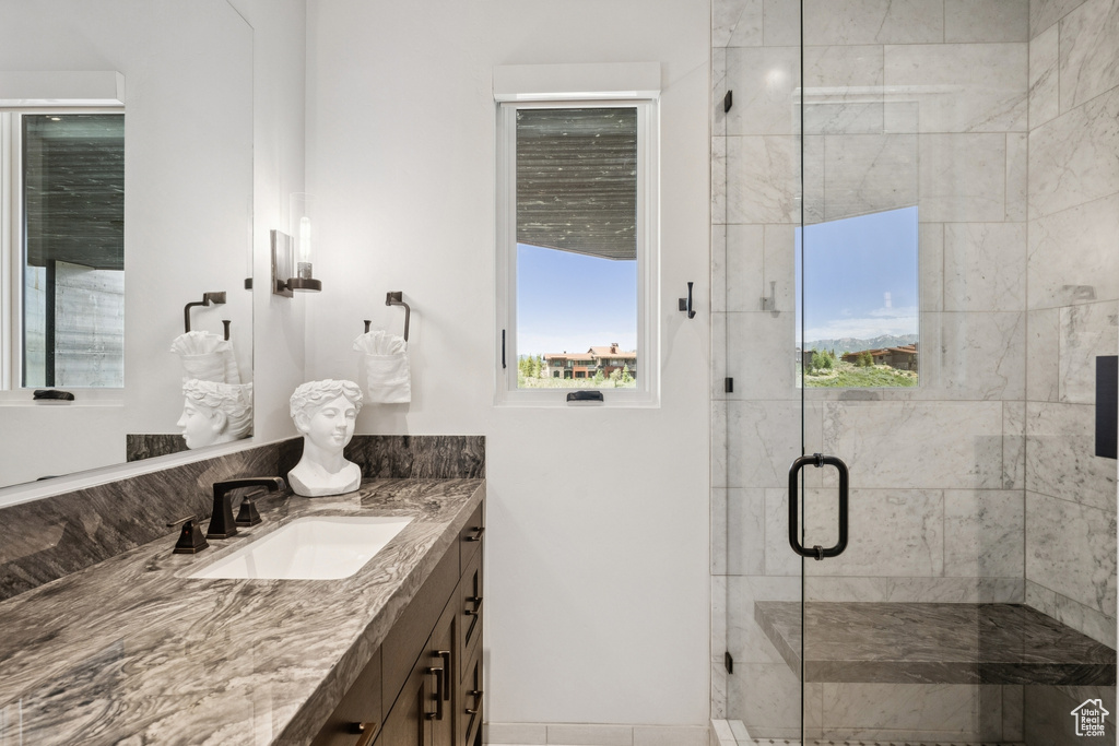 Full bathroom with vanity and a shower stall