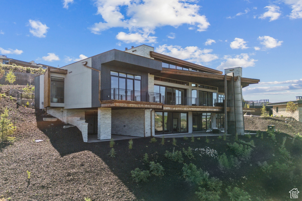 Back of property with a balcony