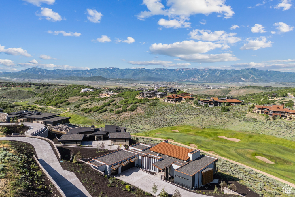 Aerial view of residential area with mountains and a golf course